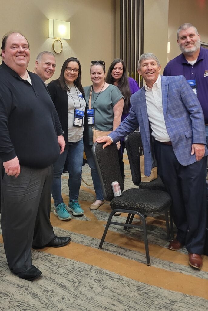 Dr. Cal Christian (in blue plaid jacket) poses with ECU staff at the 2025 UNC Finance Conference.