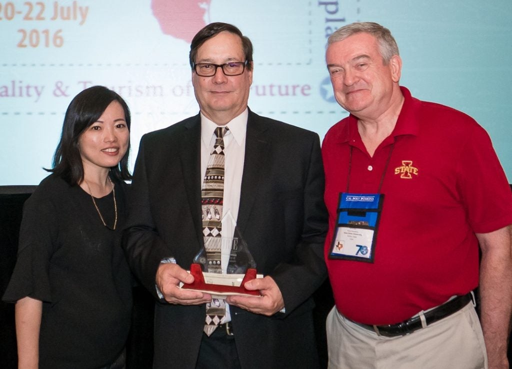 Dr. George Fenich (center) receives the Stevenson W. Fletcher Achievement Award with Dr. SoJung Lee (left) and Dr. Robert Bosselman (right) from Iowa State University.