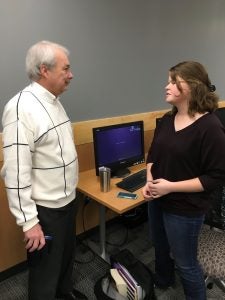 Dean Eakins speaks with the center’s first user, Junior Morgan Rose, a finance and accounting major. 