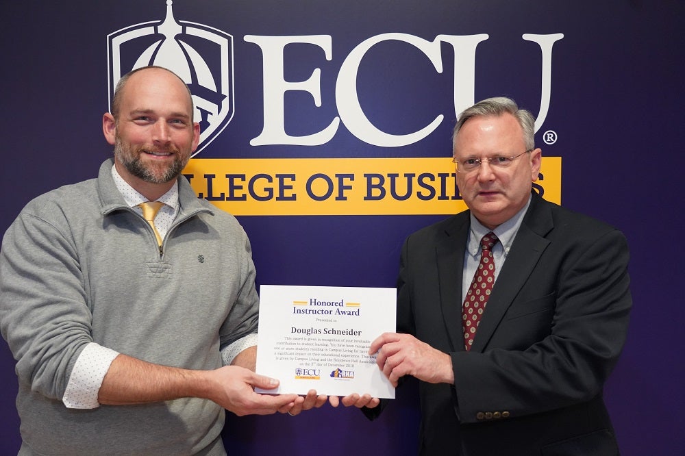 Dr. Doug Schneider receives ECU student living award.