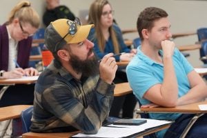 ECU's Chad Carwein speaks to students in classroom setting