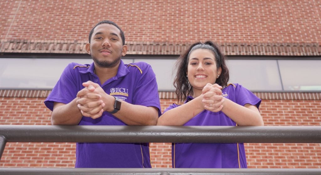 Two RMI students stand outside ECU's Bate building