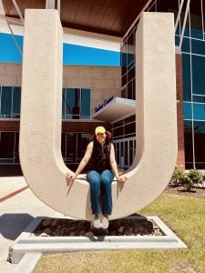 MIS Student sits outside ECU's Main Student Center