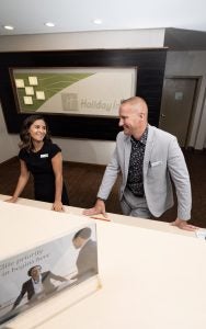 Photo of two employees at a hotel lobby