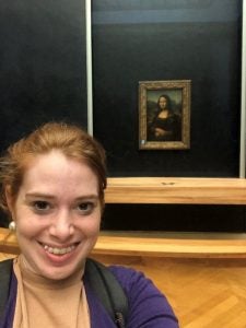MBA student takes selfie photo with the mona lisa behind her