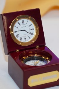 A brass compass in a wooden box. 