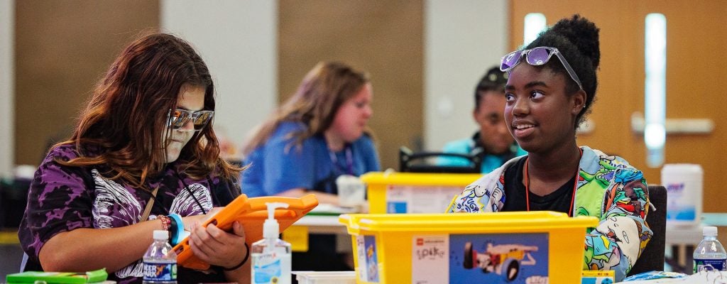 Two middle school girls work on lego robotics during ECU STEM camp.