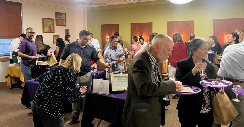 People mingle and sample food and wine at recent Food and Wine festival at ECU.