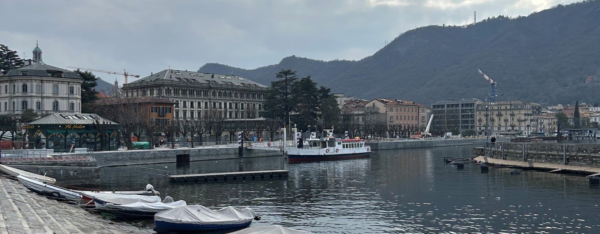 A boat pulls into port off of Lako Como in Italy.
