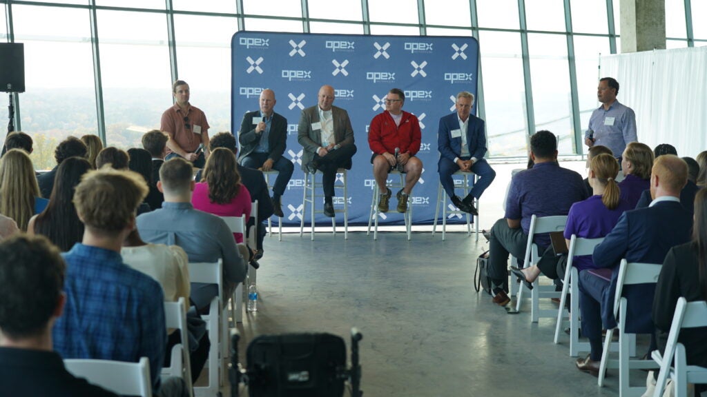 Panelists speak to a room full of college students