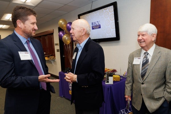 Dr. Michael Harris, left, speaks with Tom Arthur, center, and former COB Dean Dr. James Bearden, right, at the opening of the Thomas D. Arthur Graduate School of Business.