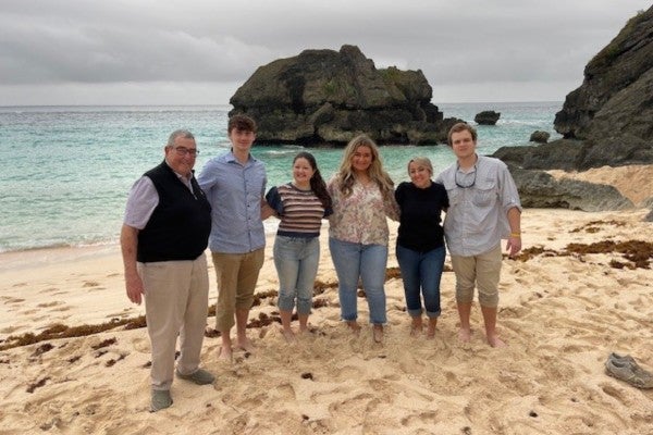 Kurt Fickling and RMI students stand on the beach in Bermuda. 