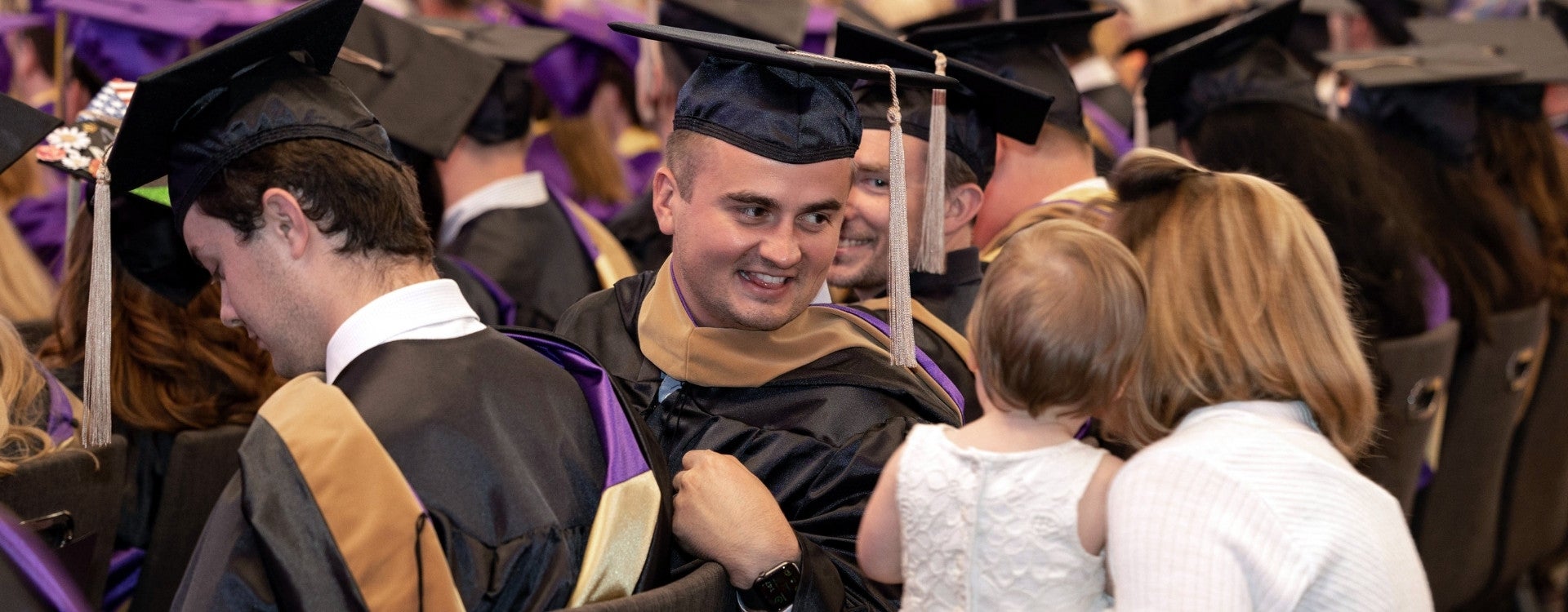 COB student looks at his child during graduation ceremonies